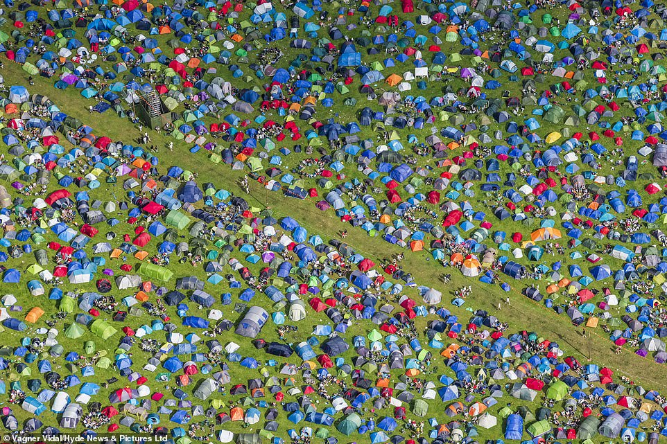 Reading's organisers Festival Republic will be hoping the Covid rules it has put in place will avoid repeats of other events this summer, including Latitude and Boardmasters. Pictured: aerial photographs showing a sea of tents at the festival