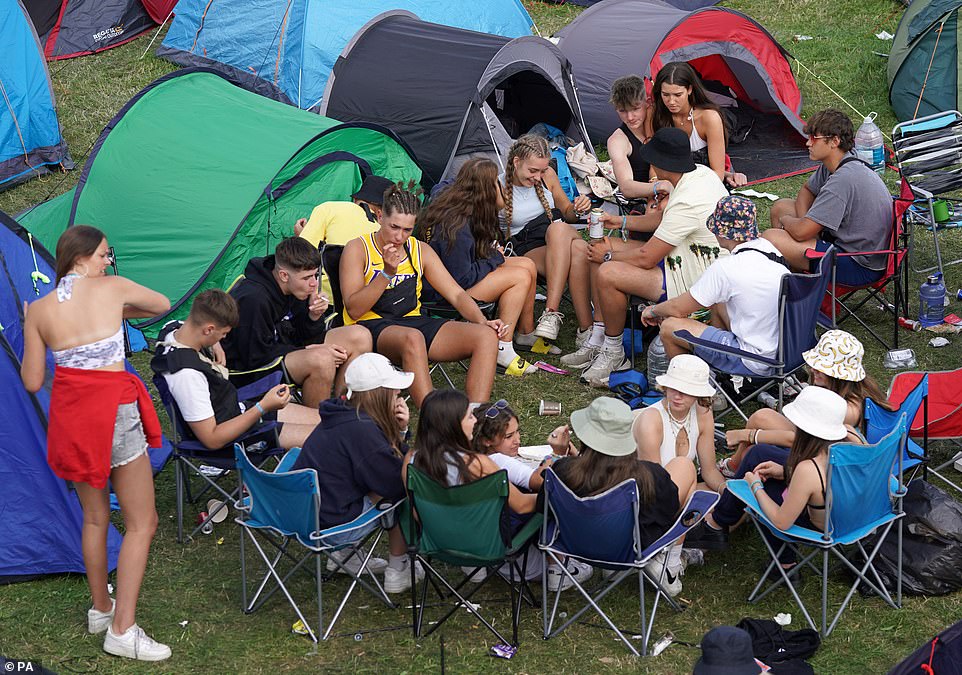 This group of friends were sitting outside their tents in a circle of chairs as they enjoyed themselves on Thursday