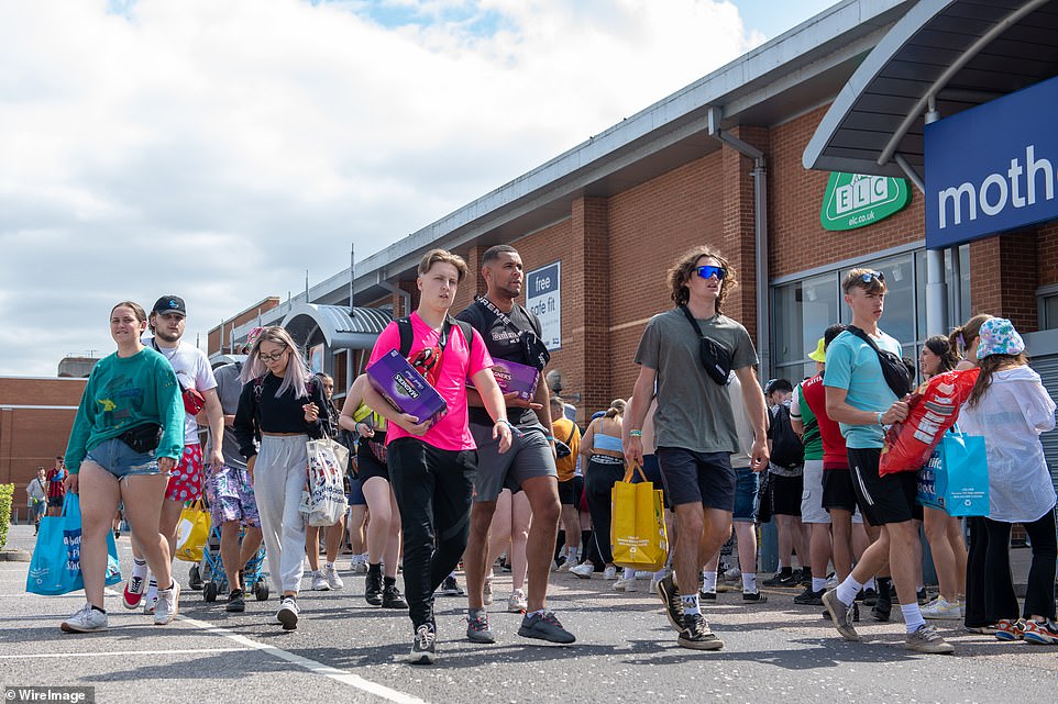 Festival goers queue up outside Aldi to stock up on food and drinks before the music starts at Reading on Friday