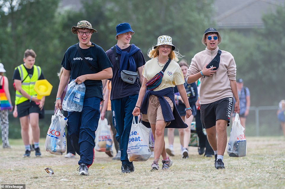 Festival goers arrive with their shopping and belongings to start setting up their tents at the designated campsites at Reading