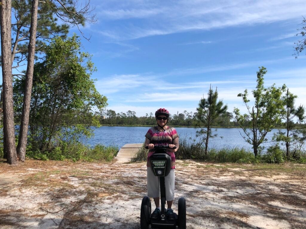 woman wearing helmet and sunglasses on segway at Gulf State Park