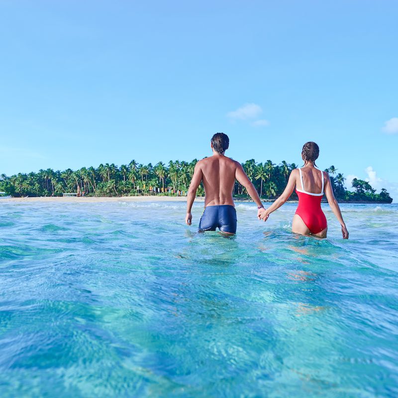 Couple walking in Caribbean waters