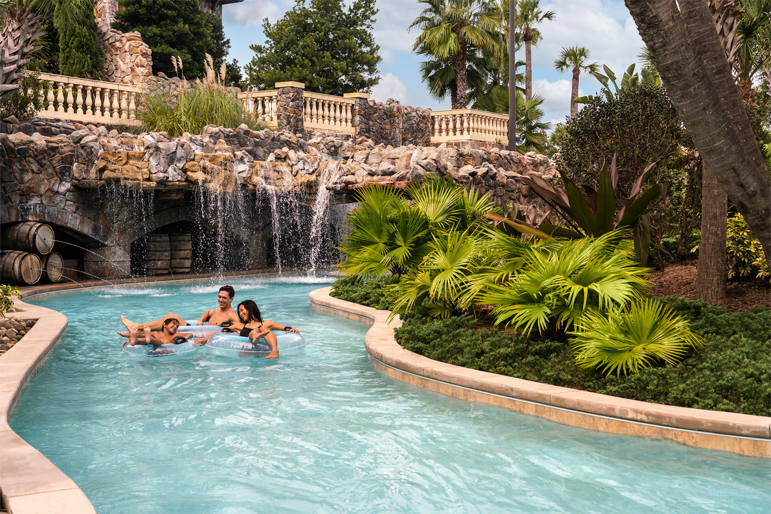 three people floating on tubes in a pool at a Disney resort in Orlando
