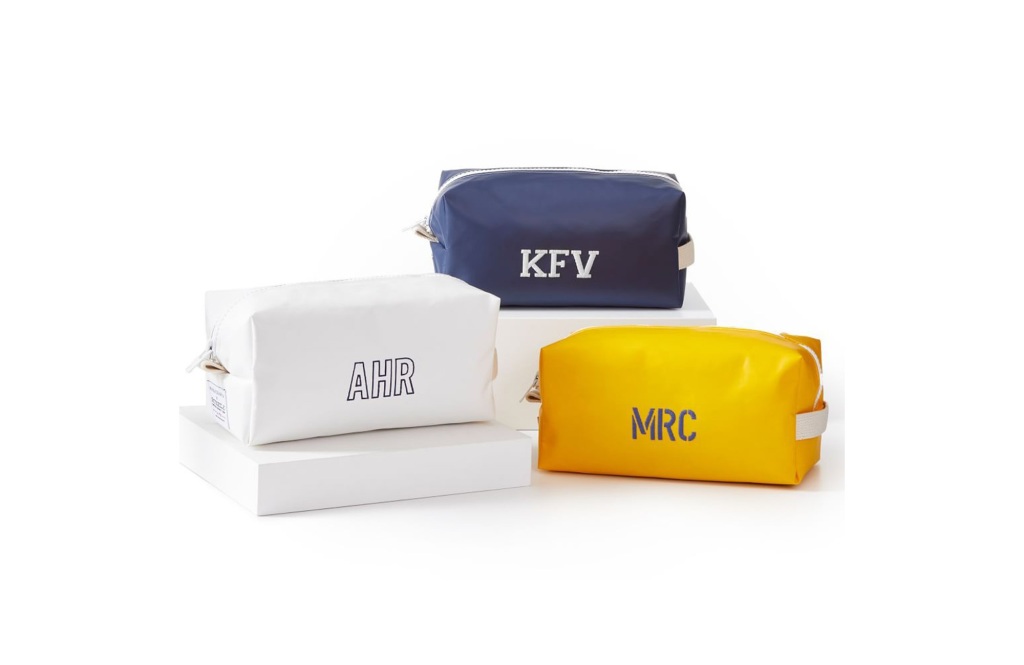 Three travel kits: blue, yellow, and white.