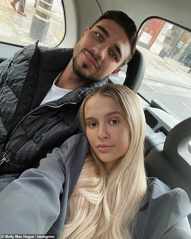 Loved-up: The former Love Island star, 23, who welcomed her first child in January, cosied up to her partner as they travelled in a taxi around the city