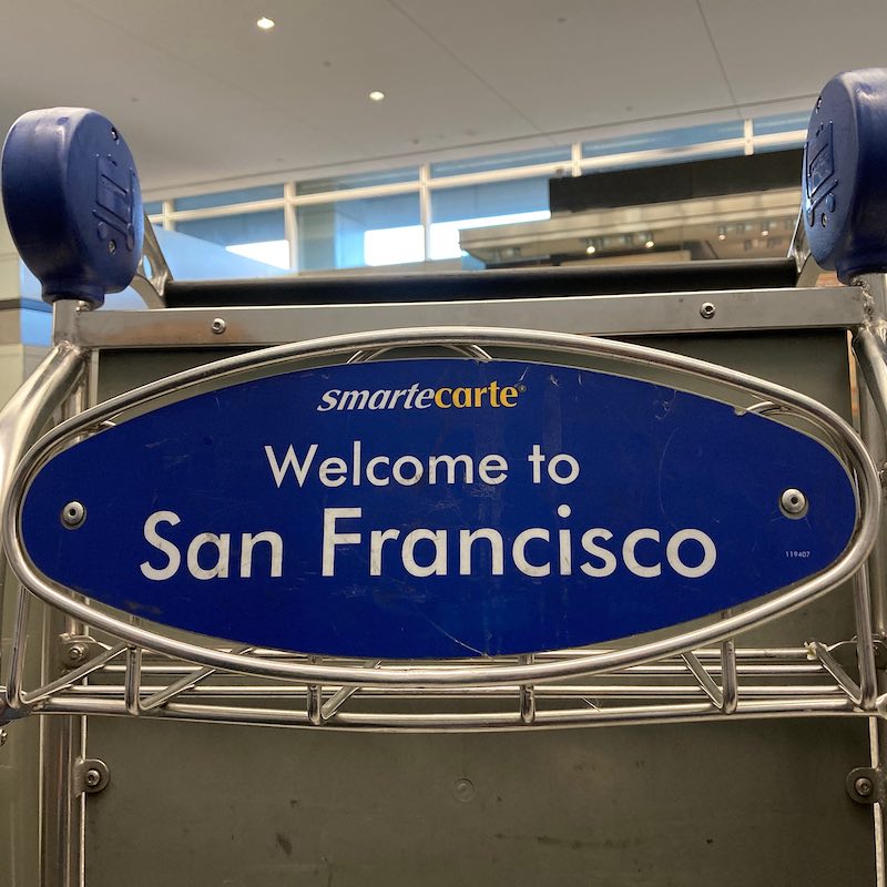 Welcome to San Francisco sign on airport baggage cart at SFO airport terminal 